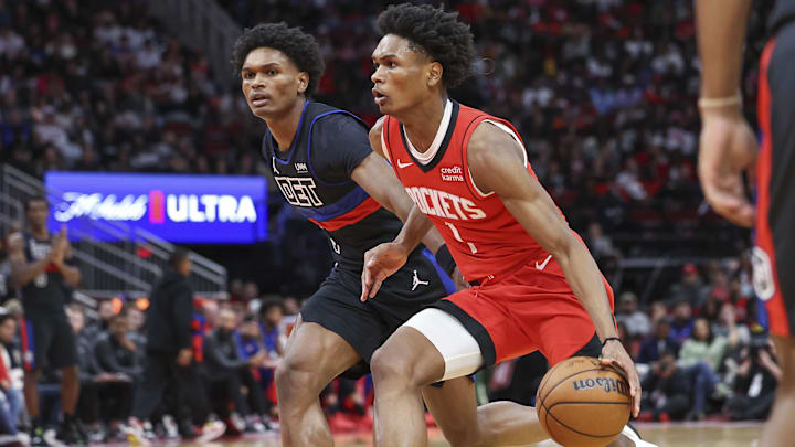 Jan 1, 2024; Houston, Texas, USA; Houston Rockets forward Amen Thompson (1) controls the ball as Detroit Pistons forward Ausar Thompson (9) defends during the third quarter at Toyota Center. Mandatory Credit: Troy Taormina-Imagn Images