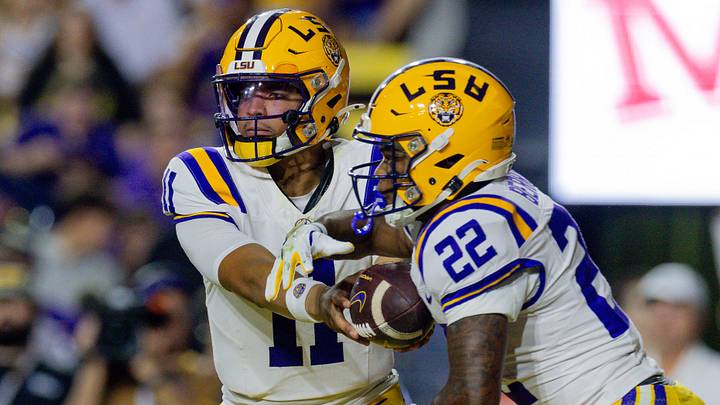 LSU Tigers quarterback Michael van Buren Jr. hands the ball off to running back Harlem Berry (22) against the Western Kentucky Hilltoppers during the first half at Tiger Stadium. 
