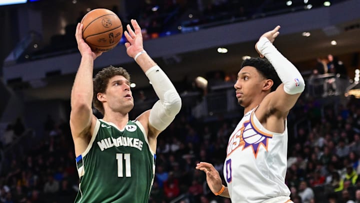 Apr 1, 2025; Milwaukee, Wisconsin, USA;  Milwaukee Bucks center Brook Lopez (11) takes a shot against Phoenix Suns guard Ryan Dunn (0) in the third quarter at Fiserv Forum. Mandatory Credit: Benny Sieu-Imagn Images