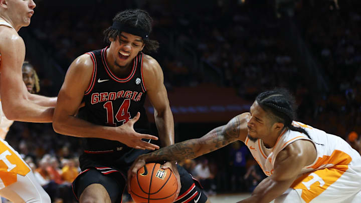 Jan 15, 2025; Knoxville, Tennessee, USA; Tennessee Volunteers guard Zakai Zeigler (5) steals the ball from Georgia Bulldogs forward Asa Newell (14) during the second half at Thompson-Boling Arena at Food City Center. Mandatory Credit: Randy Sartin-Imagn Images