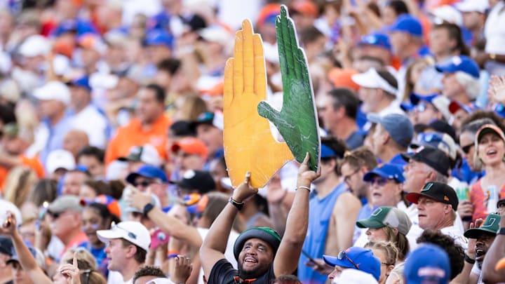 Aug 31, 2024; Gainesville, Florida, USA; A Miami Hurricanes fan holds a sign against the Florida Gators during the second half at Ben Hill Griffin Stadium. Mandatory Credit: Matt Pendleton-Imagn Images Aug 31, 2024; Gainesville, Florida, USA; A Miami Hurricanes fan holds a sign against the Florida Gators during the second half at Ben Hill Griffin Stadium. Mandatory Credit: Matt Pendleton-Imagn Images