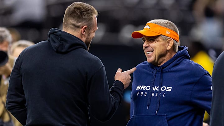 Oct 17, 2024; New Orleans, Louisiana, USA;  Denver Broncos head coach Sean Payton talks with New Orleans Saints tight end Taysom Hill (7) during the warmups before the game against the Denver Broncos at Caesars Superdome. 