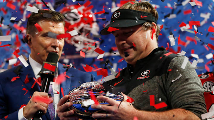 Georgia coach Kirby Smart is presented with the Chick-fil-A Peach Bowl trophy after winning the Chick-fil-A Peach Bowl NCAA College Football Playoff semifinal game between Ohio State and Georgia on Sunday, Jan 1, 2022, in Atlanta. Georgia won 42-41.

News Joshua L Jones