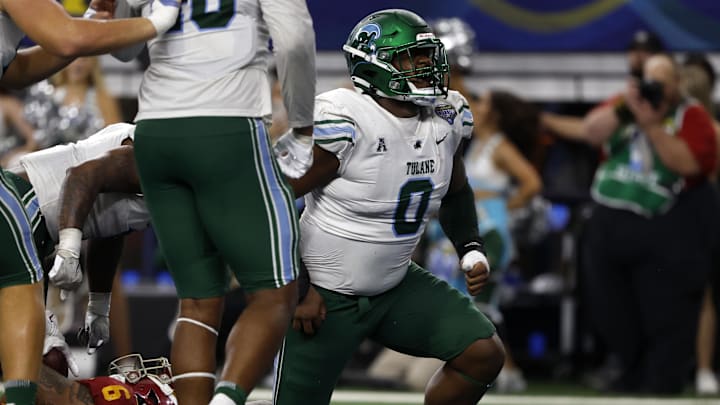 Jan 2, 2023; Arlington, Texas, USA; Tulane Green Wave defensive lineman Patrick Jenkins (0) reacts after tackling USC Trojans running back Austin Jones (6) for a safety in the fourth quarter in the 2023 Cotton Bowl at AT&T Stadium.
