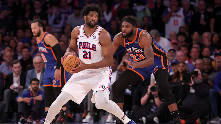 Apr 30, 2024; New York, New York, USA; Philadelphia 76ers center Joel Embiid (21) handles the ball against New York Knicks center Mitchell Robinson (23) during overtime in game 5 of the first round of the 2024 NBA playoffs at Madison Square Garden. Mandatory Credit: Brad Penner-Imagn Images