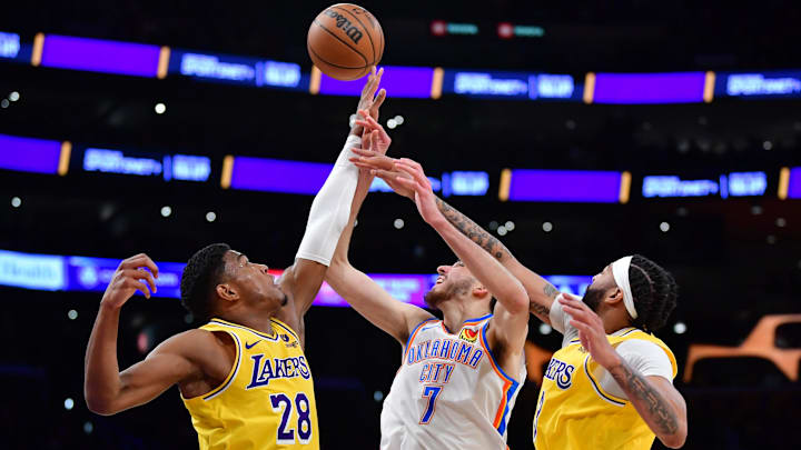 Mar 4, 2024; Los Angeles, California, USA;  Los Angeles Lakers forward Rui Hachimura (28) and forward Anthony Davis (3) defend the basket against Oklahoma City Thunder forward Chet Holmgren (7) during the second half at Crypto.com Arena. Mandatory Credit: Gary A. Vasquez-Imagn Images