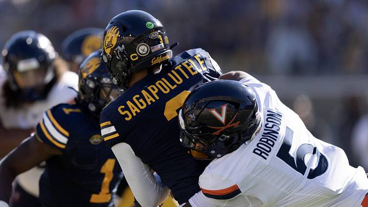 Nov 1, 2025; Berkeley, California, USA; Virginia Cavaliers linebacker Kam Robinson (5) sacks California Golden Bears quarterback Jaron-Keawe Sagapolutele (3) (obscured) during the second quarter at California Memorial Stadium. Mandatory Credit: D. Ross Cameron-Imagn Images Nov 1, 2025; Berkeley, California, USA; Virginia Cavaliers linebacker Kam Robinson (5) sacks California Golden Bears quarterback Jaron-Keawe Sagapolutele (3) (obscured) during the second quarter at California Memorial Stadium. Mandatory Credit: D. Ross Cameron-Imagn Images