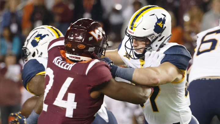 Sep 22, 2022; Blacksburg, Virginia, USA;  West Virginia Mountaineers wide receiver blocks Virginia Tech Hokies linebacker Jaden Keller (24) during the second quarter at Lane Stadium. Mandatory Credit: Reinhold Matay-Imagn Images