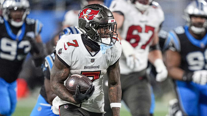 Dec 1, 2024; Charlotte, North Carolina, USA; Tampa Bay Buccaneers running back Bucky Irving (7) runs for yardage against the Carolina Panthers during the second half at Bank of America Stadium. Mandatory Credit: Jim Dedmon-Imagn Images