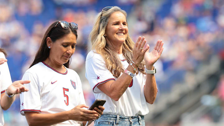 Jul 13, 2024; Harrison, New Jersey, USA; Tiffany Roberts	(5, left) and Brandi Chastain (6) are honored with members of the the 1999 US Women's World Cup team during a pregame ceremony before the match at Red Bull Arena. Mandatory Credit: Vincent Carchietta-Imagn Images