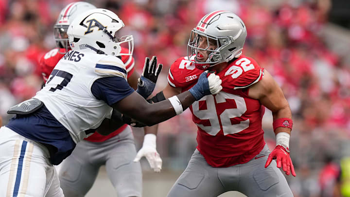 Aug 31, 2024; Columbus, OH, USA; Ohio State Buckeyes defensive end Caden Curry (92) fights through the block of Akron Zips offensive lineman Jayvin James (77) during the NCAA football game at Ohio Stadium. Ohio State won 52-6.