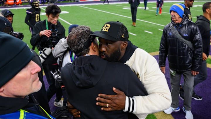 Nov 15, 2024; Seattle, Washington, USA; Washington Huskies head coach Jedd Fisch and UCLA Bruins head coach DeShaun Foster greet each other after the game at Alaska Airlines Field at Husky Stadium. Mandatory Credit: Steven Bisig-Imagn Images