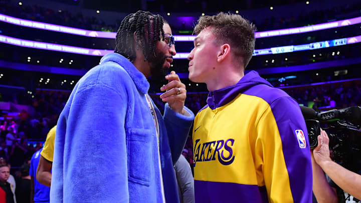 Feb 25, 2025; Los Angeles, California, USA; Dallas Mavericks forward Anthony Davis (left) reacts with Los Angeles Lakers guard Dalton Knecht (right) after the game at Crypto.com Arena. Mandatory Credit: Gary A. Vasquez-Imagn Images