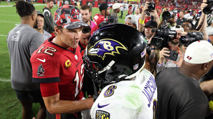 Oct 27, 2022; Tampa, Florida, USA;  Tampa Bay Buccaneers quarterback Tom Brady (12) greets Baltimore Ravens quarterback Lamar Jackson (8) after a game at Raymond James Stadium. Mandatory Credit: Nathan Ray Seebeck-Imagn Images