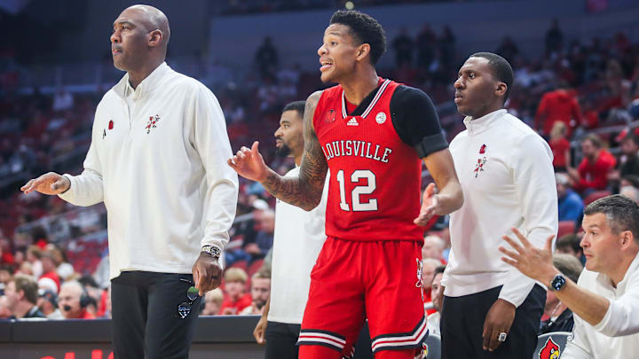Louisville Cardinals forward JJ Traynor (12) encourages his team mates from the sidelines in the