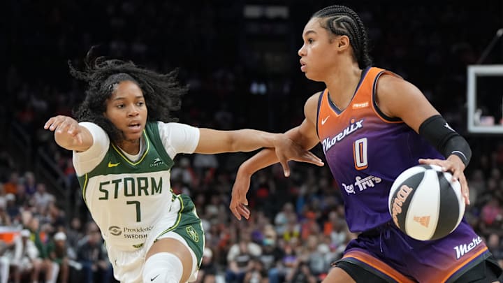 Jun 7, 2025; Phoenix, Arizona, USA; Phoenix Mercury forward Satou Sabally (0) drives on Seattle Storm guard Zia Cooke (7) in the second half at Footprint Center. Mandatory Credit: Rick Scuteri-Imagn Images