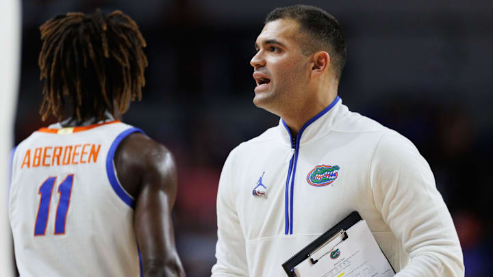 Nov 11, 2024; Gainesville, Florida, USA; Florida Gators director of basketball strategy and analytics Jonathan Safir talks with Florida Gators guard Denzel Aberdeen (11) during a timeout against the Grambling State Tigers during the second half at Exactech Arena at the Stephen C. O'Connell Center. Mandatory Credit: Matt Pendleton-Imagn Images Nov 11, 2024; Gainesville, Florida, USA; Florida Gators director of basketball strategy and analytics Jonathan Safir talks with Florida Gators guard Denzel Aberdeen (11) during a timeout against the Grambling State Tigers during the second half at Exactech Arena at the Stephen C. O'Connell Center. Mandatory Credit: Matt Pendleton-Imagn Images