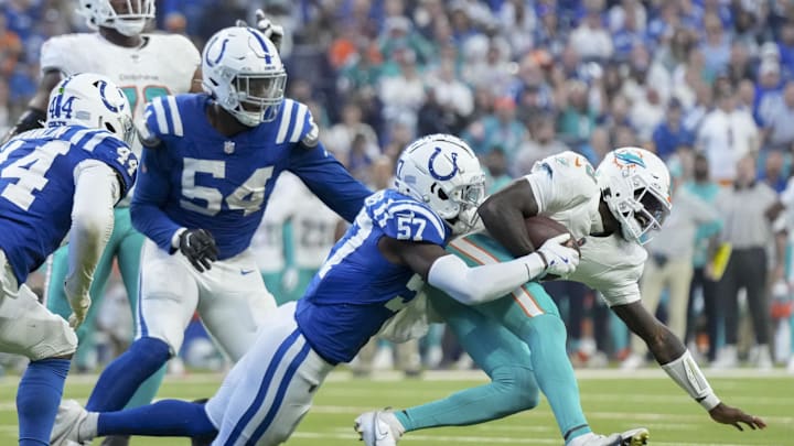 Oct 20, 2024; Indianapolis, Indiana, USA; Indianapolis Colts linebacker Jaylon Carlies (57) sacks Miami Dolphins quarterback Tyler Huntley (18) during a game against the Miami Dolphins at Lucas Oil Stadium. Mandatory Credit: Grace Hollars/IndyStar USA TODAY Network via Imagn Images Oct 20, 2024; Indianapolis, Indiana, USA; Indianapolis Colts linebacker Jaylon Carlies (57) sacks Miami Dolphins quarterback Tyler Huntley (18) during a game against the Miami Dolphins at Lucas Oil Stadium. Mandatory Credit: Grace Hollars/IndyStar USA TODAY Network via Imagn Images