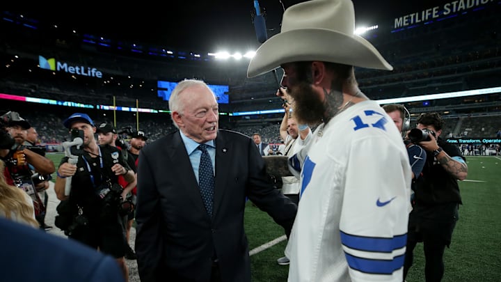 Dallas Cowboys owner Jerry Jones greets recording artist Post Malone on the field before a game against the New York Giants.