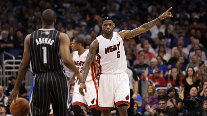 Miami Heat forward LeBron James (6) defends as Orlando Magic point guard Gilbert Arenas (1) dribbles the ball at Amway Center. 