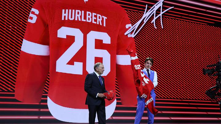 Jun 26, 2026; Buffalo, New York, USA; JP Hurlbert reacts beside NHL commissioner Gary Bettman after being selected with the twenty third pick in the first round of the 2026 NHL Draft by the Detroit Red Wings at KeyBank Center. Mandatory Credit: Timothy T. Ludwig-Imagn Images