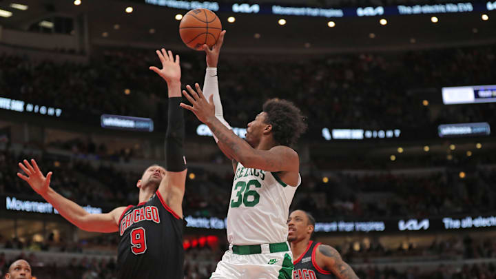 Apr 6, 2022; Chicago, Illinois, USA;Boston Celtics guard Marcus Smart (36) shoots over Chicago Bulls center Nikola Vucevic (9)  during the first half at the United Center. Mandatory Credit: Dennis Wierzbicki-Imagn Images