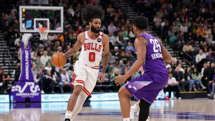 Mar 17, 2025; Salt Lake City, Utah, USA;  Chicago Bulls guard Coby White (0) dribbles the ball towards Utah Jazz forward Brice Sensabaugh (28) during the second half at Delta Center. Mandatory Credit: Chris Nicoll-Imagn Images