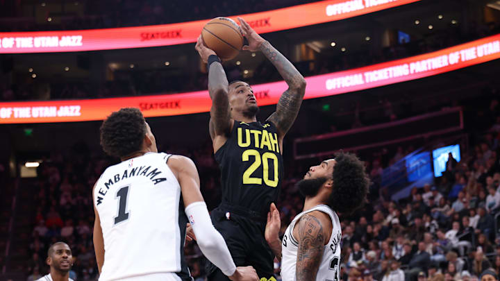 Oct 31, 2024; Salt Lake City, Utah, USA; Utah Jazz forward John Collins (20) drives between San Antonio Spurs center Victor Wembanyama (1) and forward Julian Champagnie (30) during the fourth quarter at Delta Center. Mandatory Credit: Rob Gray-Imagn Images Oct 31, 2024; Salt Lake City, Utah, USA; Utah Jazz forward John Collins (20) drives between San Antonio Spurs center Victor Wembanyama (1) and forward Julian Champagnie (30) during the fourth quarter at Delta Center. Mandatory Credit: Rob Gray-Imagn Images