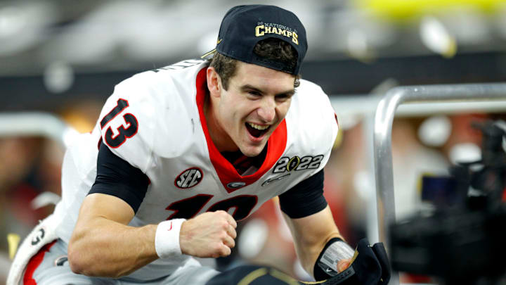 Georgia Bulldogs quarterback Stetson Bennett (13) reacts on the podium Tuesday, Jan. 11, 2022, after defeating Alabama in the College Football Playoff National Championship at Lucas Oil Stadium in Indianapolis.