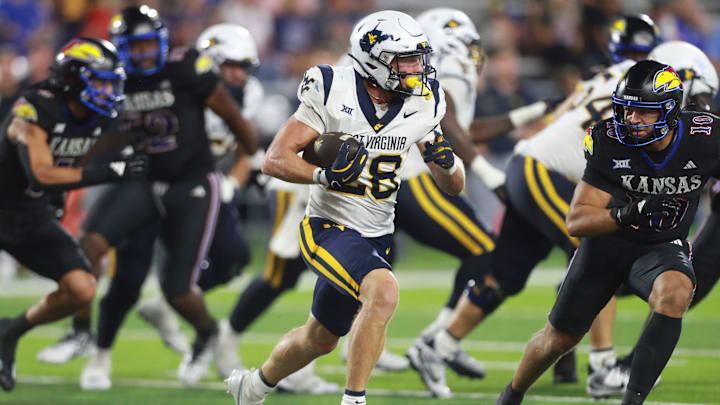 West Virginia Mountaineers running back Tyler Jacklich (28) runs the ball during the second half of the game against Kansas Jayhawks at David Booth Kansas Memorial Stadium on Sept. 20, 2025. West Virginia Mountaineers running back Tyler Jacklich (28) runs the ball during the second half of the game against Kansas Jayhawks at David Booth Kansas Memorial Stadium on Sept. 20, 2025.