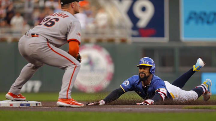 May 9, 2025; Minneapolis, Minnesota, USA; Minnesota Twins center fielder Byron Buxton (25) slides into third base for a triple as San Francisco Giants third baseman Matt Chapman (26) awaits the throw in the first inning at Target Field. Mandatory Credit: Bruce Kluckhohn-Imagn Images