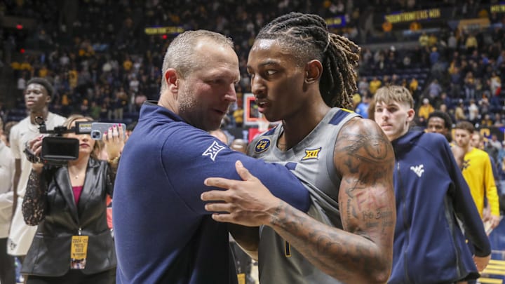 Mar 8, 2025; Morgantown, West Virginia, USA; West Virginia Mountaineers head coach Darian DeVries and guard Javon Small (7) celebrate after defeating the UCF Knights at WVU Coliseum. Mandatory Credit: Ben Queen-Imagn Images Mar 8, 2025; Morgantown, West Virginia, USA; West Virginia Mountaineers head coach Darian DeVries and guard Javon Small (7) celebrate after defeating the UCF Knights at WVU Coliseum. Mandatory Credit: Ben Queen-Imagn Images