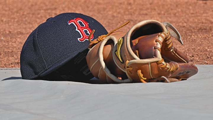 May 10, 2025; Kansas City, Missouri, USA;  A general view of a Boston Red Sox's cap and glove on the field before a game against the Kansas City Royals at Kauffman Stadium. Mandatory Credit: Peter Aiken-Imagn Images