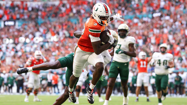Sep 13, 2025; Miami Gardens, Florida, USA; Miami Hurricanes wide receiver Joshua Moore (3) runs into the end zone for a touchdown against the South Florida Bulls in the first quarter at Hard Rock Stadium. Mandatory Credit: Nathan Ray Seebeck-Imagn Images