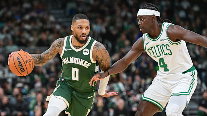 Nov 10, 2024; Milwaukee, Wisconsin, USA; Milwaukee Bucks guard Damian Lillard (0) drives for the basket against Boston Celtics guard Jrue Holiday (4) in the first quarter at Fiserv Forum. Mandatory Credit: Benny Sieu-Imagn Images