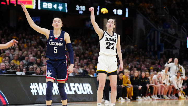 Apr 5, 2024; Cleveland, OH, USA; Iowa Hawkeyes guard Caitlin Clark (22) and Connecticut Huskies guard Paige Bueckers (5) react in the second quarter in the semifinals of the Final Four of the womens 2024 NCAA Tournament at Rocket Mortgage FieldHouse. Mandatory Credit: Kirby Lee-Imagn Images Apr 5, 2024; Cleveland, OH, USA; Iowa Hawkeyes guard Caitlin Clark (22) and Connecticut Huskies guard Paige Bueckers (5) react in the second quarter in the semifinals of the Final Four of the womens 2024 NCAA Tournament at Rocket Mortgage FieldHouse. Mandatory Credit: Kirby Lee-Imagn Images