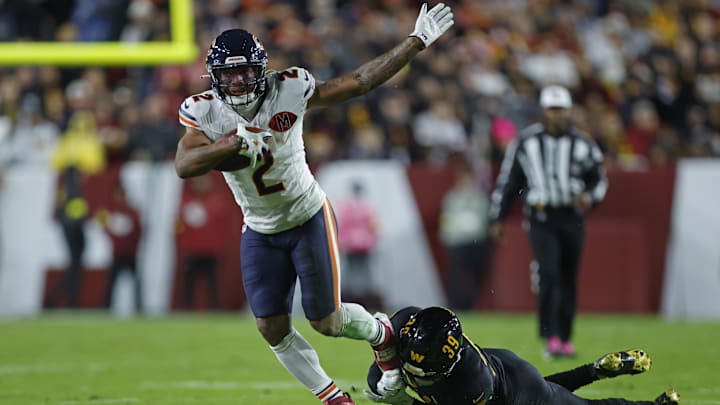 Oct 13, 2025; Landover, Maryland, USA; Chicago Bears wide receiver DJ Moore (2) escapes the tackle of Washington Commanders safety Jeremy Reaves (39) during the first quarter at Northwest Stadium. Mandatory Credit: Peter Casey-Imagn Images Oct 13, 2025; Landover, Maryland, USA; Chicago Bears wide receiver DJ Moore (2) escapes the tackle of Washington Commanders safety Jeremy Reaves (39) during the first quarter at Northwest Stadium. Mandatory Credit: Peter Casey-Imagn Images
