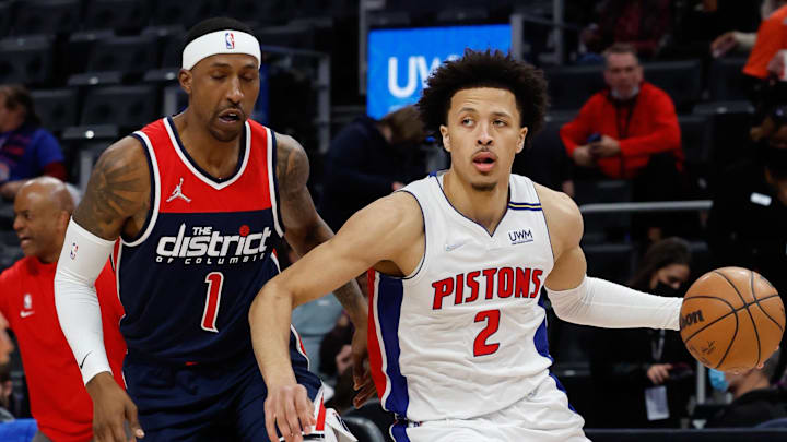 Dec 8, 2021; Detroit, Michigan, USA;  Detroit Pistons guard Cade Cunningham (2) dribbles on Washington Wizards guard Kentavious Caldwell-Pope (1) at Little Caesars Arena. Mandatory Credit: Rick Osentoski-Imagn Images