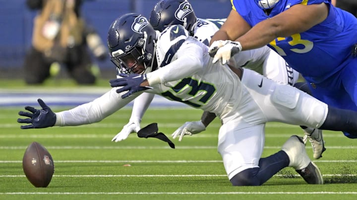 Jan 5, 2025; Inglewood, California, USA; Seattle Seahawks linebacker Ernest Jones IV (13) eats Los Angeles Rams guard Steve Avila (73) to the ball as he recovers a fumble in the first half at SoFi Stadium.