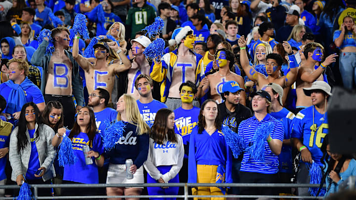 Nov 19, 2022; Pasadena, California, USA; UCLA Bruins student fan section cheers against the Southern California Trojans during the first half at the Rose Bowl. Mandatory Credit: Gary A. Vasquez-Imagn Images