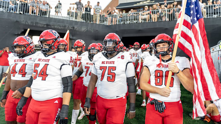 Sep 11, 2025; Winston-Salem, North Carolina, USA; North Carolina State Wolfpack enter the field against for a game against the Wake Forest Demon Deacons at Allegacy Federal Credit Union Stadium. Mandatory Credit: Luke Jamroz-Imagn Images Sep 11, 2025; Winston-Salem, North Carolina, USA; North Carolina State Wolfpack enter the field against for a game against the Wake Forest Demon Deacons at Allegacy Federal Credit Union Stadium. Mandatory Credit: Luke Jamroz-Imagn Images