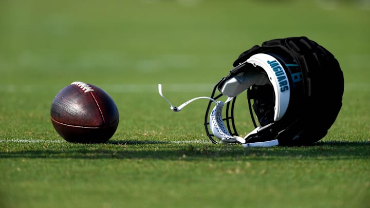 Aug 17, 2020; Jacksonville, Florida, USA; General view of an NFL football and Jacksonville Jaguars helmet on the field during training camp at Dream Finders Homes Practice Complex. Mandatory Credit: Douglas DeFelice-Imagn Images Aug 17, 2020; Jacksonville, Florida, USA; General view of an NFL football and Jacksonville Jaguars helmet on the field during training camp at Dream Finders Homes Practice Complex. Mandatory Credit: Douglas DeFelice-Imagn Images
