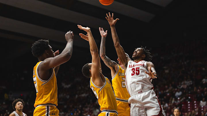 Dec 22, 2024; Tuscaloosa, Alabama, USA; Alabama Crimson Tide forward Derrion Reid (35) shoots against Kent State Golden Flashes forward Delrecco Gillespie (23), forward Donovan Hunter (55), and forward Anthony Morales (22) during the first half at Coleman Coliseum. Mandatory Credit: Will McLelland-Imagn Images