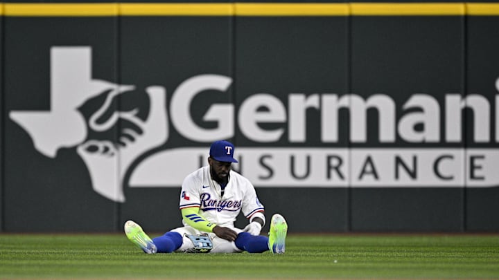May 1, 2025; Arlington, Texas, USA; Texas Rangers right fielder Adolis García (53) adjusts his socks after he catches a fly ball hit by Athletics shortstop Jacob Wilson (not pictured) during the first inning at Globe Life Field. Mandatory Credit: Jerome Miron-Imagn Images