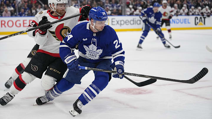Apr 20, 2025; Toronto, Ontario, CAN; Toronto Maple Leafs forward Scott Laughton (24)and Ottawa Senators defenseman Nick Jensen (3) battle for position during the first period of game one of the first round of the 2025 Stanley Cup Playoffs at Scotiabank Arena. Mandatory Credit: John E. Sokolowski-Imagn Images