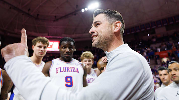 Feb 1, 2026; Gainesville, Florida, USA; Florida Gators head coach Todd Golden huddles with Florida Gators center Rueben Chinyelu (9) and teammates after a game against the Alabama Crimson Tide at Exactech Arena at the Stephen C. O'Connell Center. Mandatory Credit: Matt Pendleton-Imagn Images