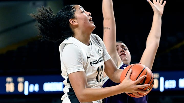 Vanderbilt forward Khamil Pierre (12) drives to the basket against Lipscomb forward Isabella Pitta, right, during an NCAA college basketball game Monday, Nov. 4, 2024, in Nashville, Tenn.