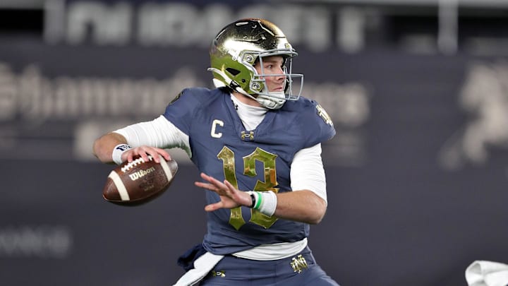 Nov 23, 2024; New York, New York, USA; Notre Dame Fighting Irish quarterback Riley Leonard (13) throws a pass against the Army Black Knights during the first half at Yankee Stadium. Mandatory Credit: Danny Wild-Imagn Images