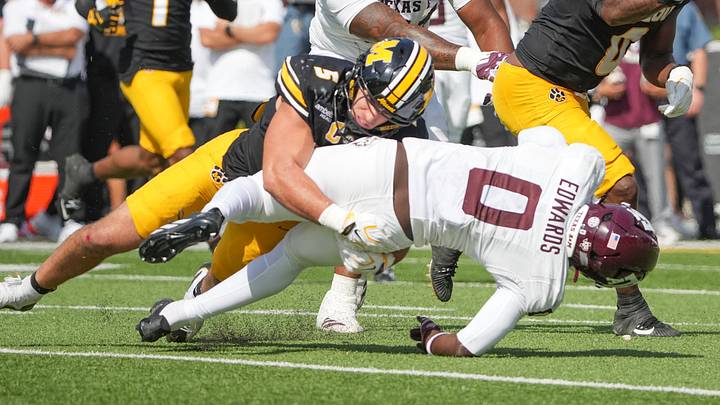 Oct 10, 2026; Columbia, Missouri, USA; Texas A&M Aggies running back KJ Edwards (0) runs the ball as Missouri Tigers linebacker Nicholas Rodriguez (5) makes the tackle during the first half of the game at Faurot Field at Memorial Stadium. Mandatory Credit: Denny Medley-Imagn Images Oct 10, 2026; Columbia, Missouri, USA; Texas A&M Aggies running back KJ Edwards (0) runs the ball as Missouri Tigers linebacker Nicholas Rodriguez (5) makes the tackle during the first half of the game at Faurot Field at Memorial Stadium. Mandatory Credit: Denny Medley-Imagn Images