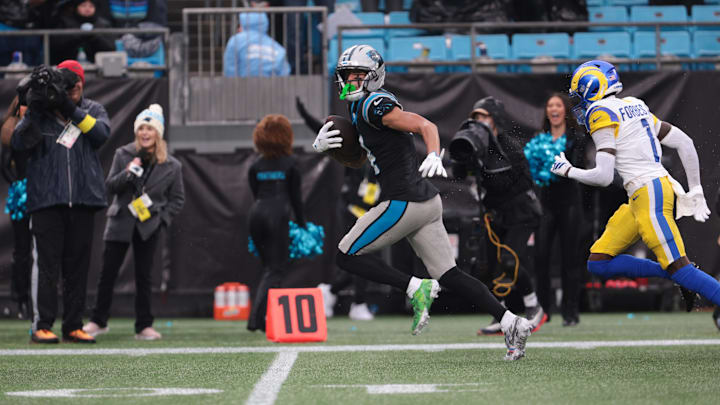 Nov 30, 2025; Charlotte, North Carolina, USA; Carolina Panthers wide receiver Tetairoa McMillan (4) runs after making a catch as Los Angeles Rams cornerback Emmanuel Forbes Jr. (1) defends during the fourth quarter at Bank of America Stadium. Mandatory Credit: Scott Kinser-Imagn Images Nov 30, 2025; Charlotte, North Carolina, USA; Carolina Panthers wide receiver Tetairoa McMillan (4) runs after making a catch as Los Angeles Rams cornerback Emmanuel Forbes Jr. (1) defends during the fourth quarter at Bank of America Stadium. Mandatory Credit: Scott Kinser-Imagn Images